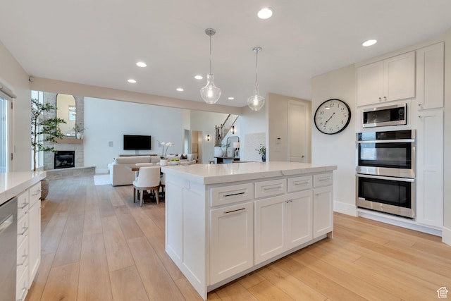 14709 S Cedar Knoll Cir, Herriman, UT 84096 - kitchen with appliances with stainless steel finishes, light wood-style flooring, recessed lighting, and white cabinets
