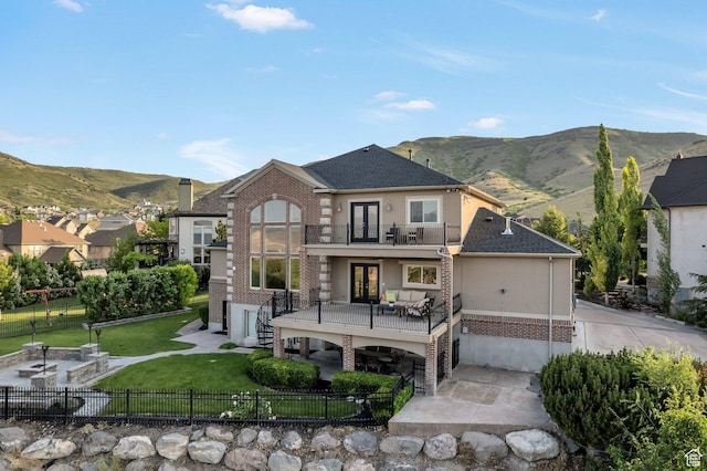 14709 S Cedar Knoll Cir, Herriman, UT 84096 - rear view of property with a balcony, french doors, a patio, and a mountain view
