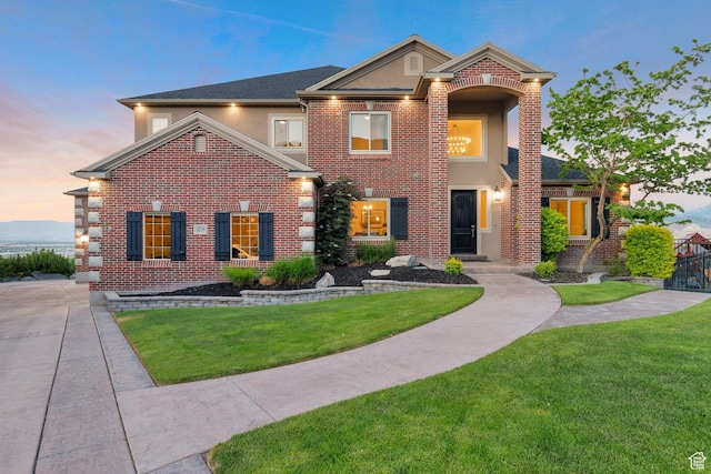 14709 S Cedar Knoll Cir, Herriman, UT 84096 - traditional-style house with stucco siding, a lawn, and brick siding
