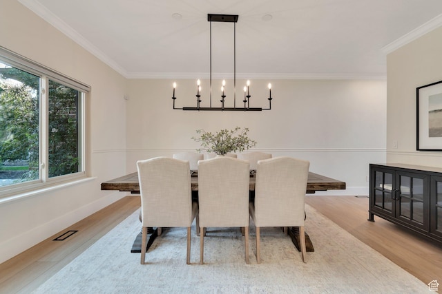 14709 S Cedar Knoll Cir, Herriman, UT 84096 - dining room with light wood finished floors, crown molding, a chandelier, and baseboards