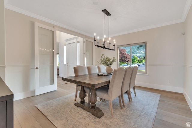 14709 S Cedar Knoll Cir, Herriman, UT 84096 - dining area featuring a chandelier, light wood-type flooring, crown molding, and baseboards