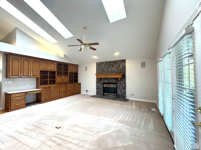 362 S Glen Cir E, Fruit Heights, UT 84037 - unfurnished living room with a skylight, high vaulted ceiling, a fireplace, a ceiling fan, and baseboards