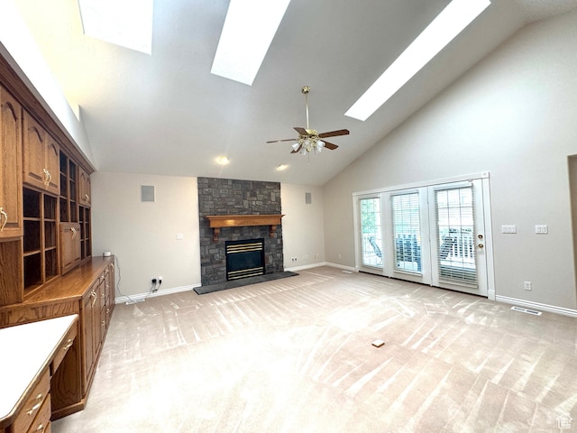 362 S Glen Cir E, Fruit Heights, UT 84037 - unfurnished living room with a skylight, baseboards, high vaulted ceiling, a stone fireplace, and light carpet