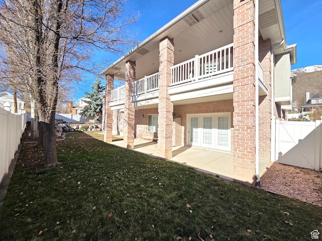 362 S Glen Cir E, Fruit Heights, UT 84037 - back of house featuring a balcony, a patio, and brick siding