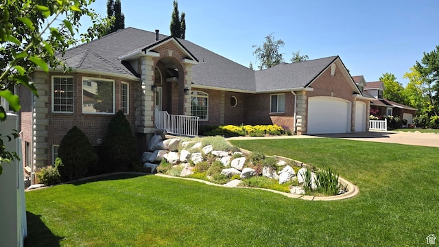 362 S Glen Cir E, Fruit Heights, UT 84037 - view of front of property with brick siding, a garage, driveway, a front yard, and roof with shingles