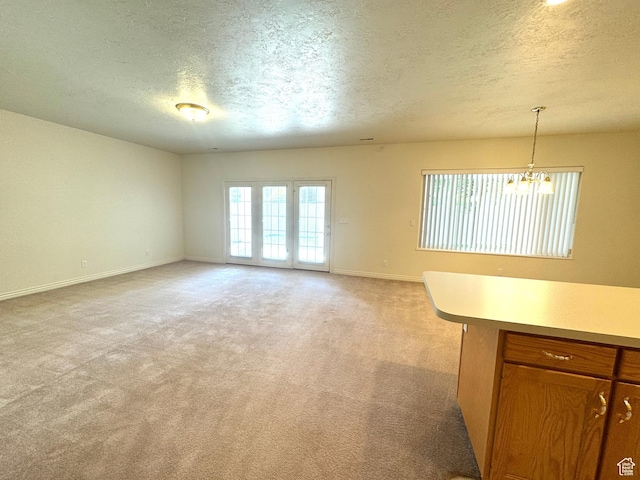 362 S Glen Cir E, Fruit Heights, UT 84037 - unfurnished living room with a textured ceiling, baseboards, light carpet, and a chandelier
