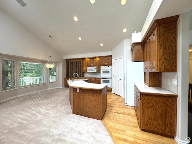 362 S Glen Cir E, Fruit Heights, UT 84037 - kitchen with white appliances, brown cabinets, recessed lighting, a sink, and hanging light fixtures