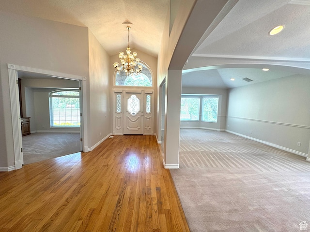 362 S Glen Cir E, Fruit Heights, UT 84037 - foyer entrance featuring healthy amount of natural light, arched walkways, lofted ceiling, baseboards, and a chandelier