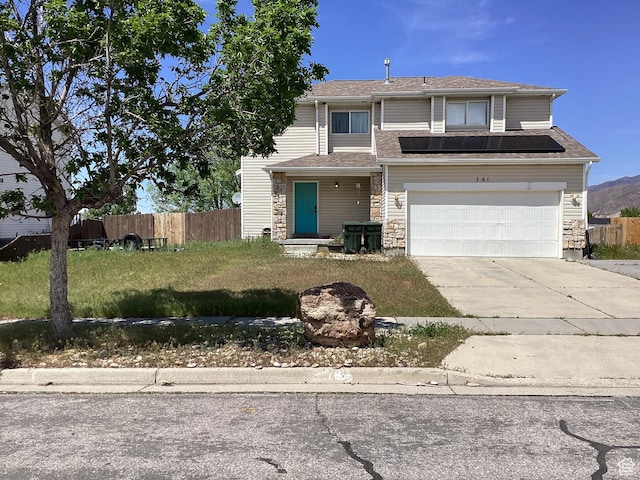 781 E Valley View Dr, Tooele, UT 84074 - view of front of home featuring concrete driveway, an attached garage, and stone siding