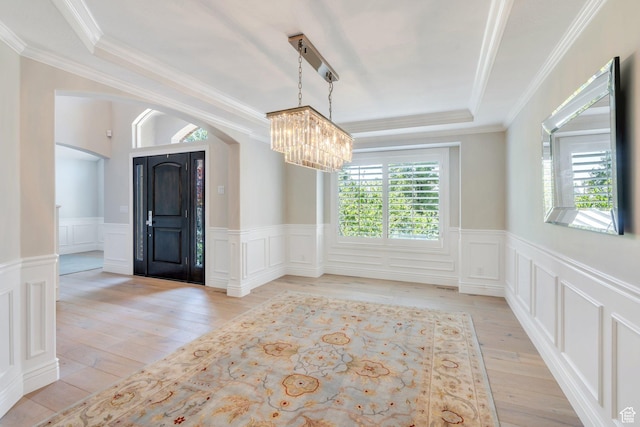 719 E Hampton Ct N, Alpine, UT 84004 - unfurnished room featuring arched walkways, a chandelier, a raised ceiling, light wood-style flooring, and wainscoting