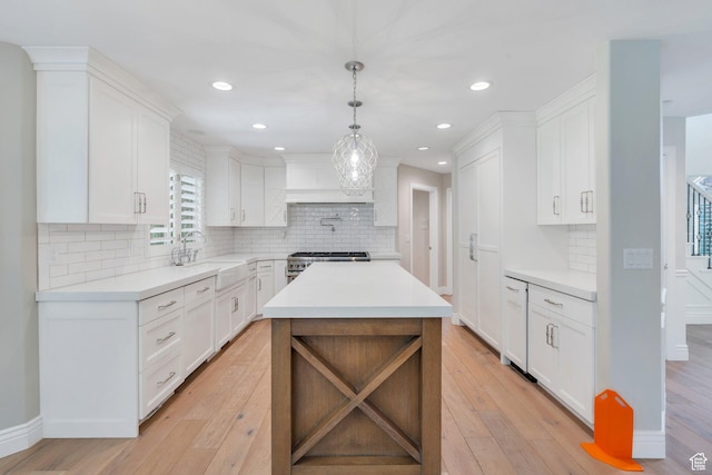 719 E Hampton Ct N, Alpine, UT 84004 - kitchen with a sink, light countertops, light wood-style floors, decorative backsplash, and recessed lighting