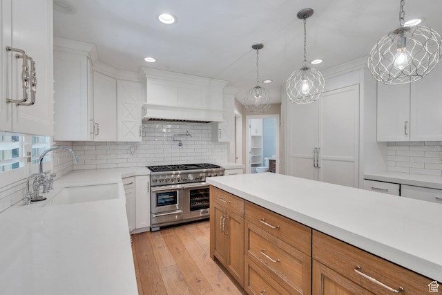 719 E Hampton Ct N, Alpine, UT 84004 - kitchen with double oven range, custom exhaust hood, a sink, backsplash, and light countertops