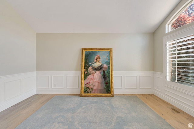 719 E Hampton Ct N, Alpine, UT 84004 - spare room with wood finished floors, a wainscoted wall, and lofted ceiling