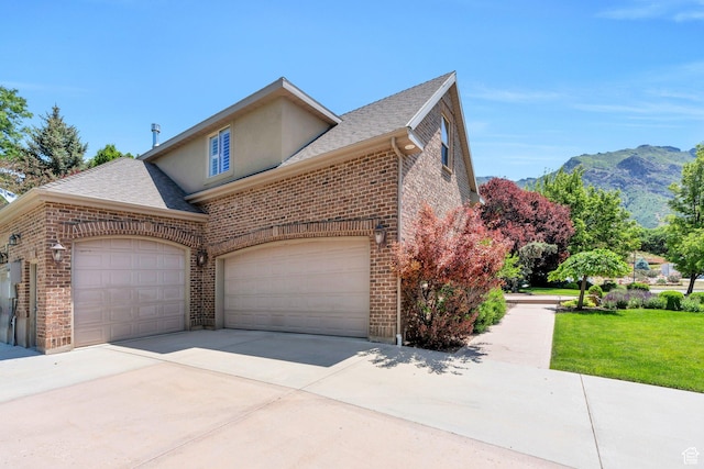 719 E Hampton Ct N, Alpine, UT 84004 - view of property exterior with brick siding, driveway, stucco siding, roof with shingles, and a mountain view