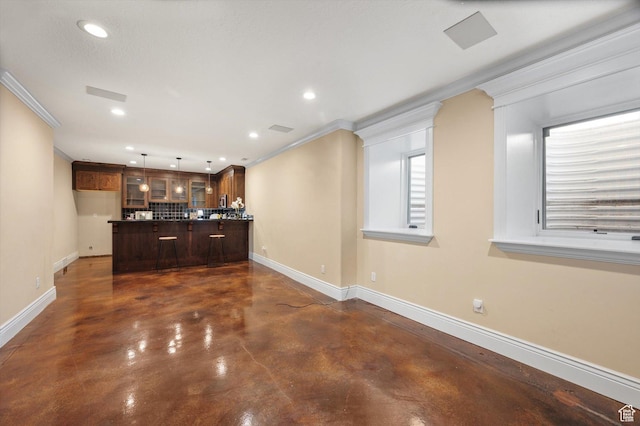 521 E 900 S, Salt Lake City, UT 84105 - unfurnished living room featuring finished concrete floors, baseboards, crown molding, and recessed lighting