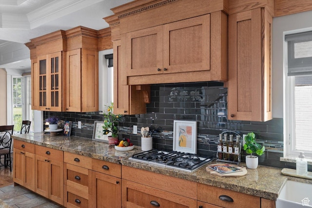521 E 900 S, Salt Lake City, UT 84105 - kitchen with stainless steel gas cooktop, crown molding, tasteful backsplash, glass insert cabinets, and stone countertops