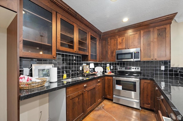521 E 900 S, Salt Lake City, UT 84105 - kitchen featuring stainless steel appliances, concrete flooring, a sink, tasteful backsplash, and glass insert cabinets