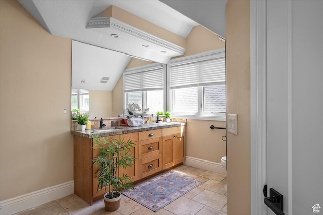 521 E 900 S, Salt Lake City, UT 84105 - full bathroom featuring double vanity, baseboards, lofted ceiling, and toilet