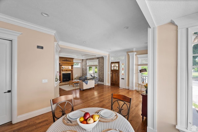 521 E 900 S, Salt Lake City, UT 84105 - dining space with wood finished floors, a fireplace, ornamental molding, and baseboards