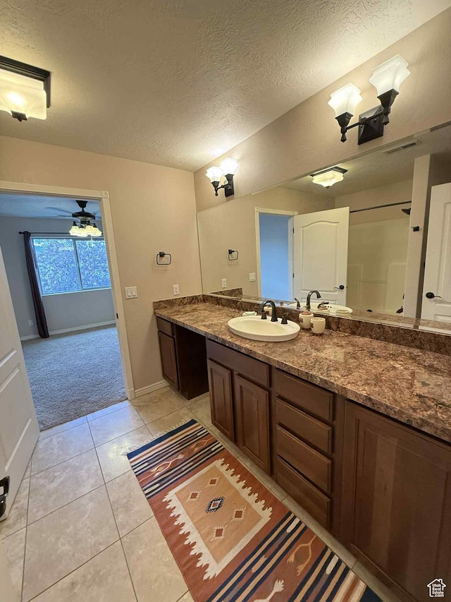 639 N 1550 E, Price, UT 84501 - bathroom featuring a textured ceiling, vanity, baseboards, and tile patterned floors