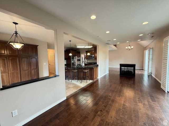 639 N 1550 E, Price, UT 84501 - living room featuring hardwood / wood-style floors, baseboards, recessed lighting, a chandelier, and a multi sided fireplace
