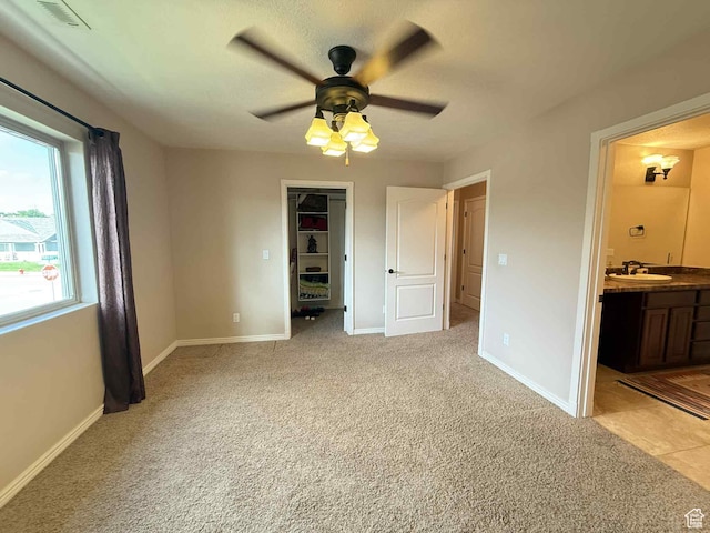639 N 1550 E, Price, UT 84501 - unfurnished bedroom with a sink, light colored carpet, baseboards, and ensuite bathroom