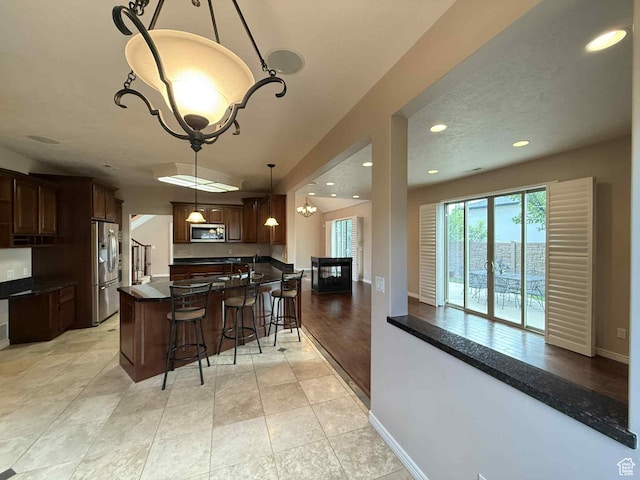 639 N 1550 E, Price, UT 84501 - kitchen featuring appliances with stainless steel finishes, a chandelier, a breakfast bar, dark countertops, and recessed lighting