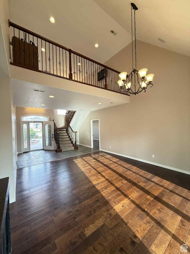 639 N 1550 E, Price, UT 84501 - unfurnished living room with dark wood finished floors, stairway, high vaulted ceiling, a chandelier, and baseboards