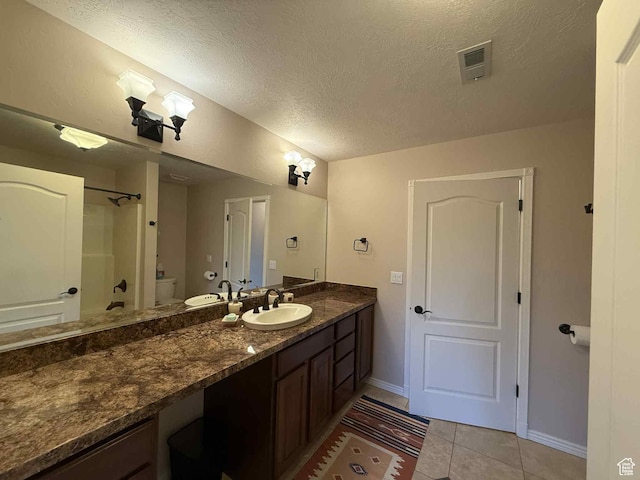 639 N 1550 E, Price, UT 84501 - bathroom with vanity, toilet, tile patterned floors, baseboards, and a textured ceiling