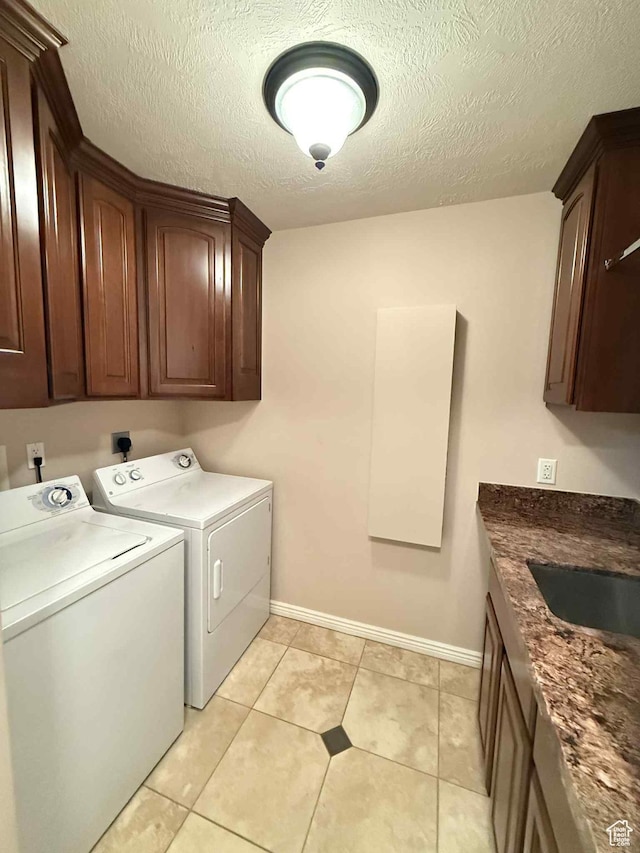 639 N 1550 E, Price, UT 84501 - laundry area with washer and dryer, cabinet space, baseboards, a textured ceiling, and light tile patterned flooring