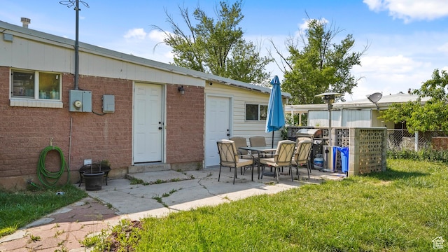 850 N Monroe Blvd E, Ogden, UT 84404 - rear view of property featuring brick siding and a patio