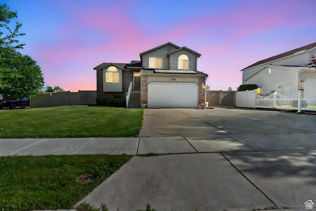2456 W 1600 N, Clinton, UT 84015 - view of front facade with concrete driveway, a garage, brick siding, and a gate