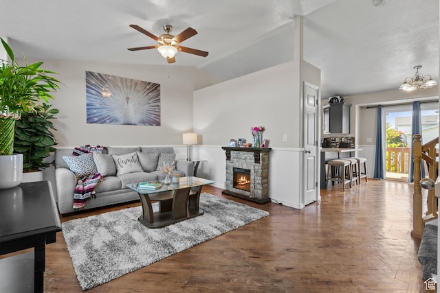 2456 W 1600 N, Clinton, UT 84015 - living room with ceiling fan, a fireplace, wood finished floors, vaulted ceiling, and a chandelier