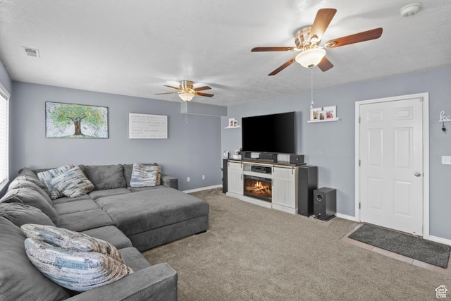 2456 W 1600 N, Clinton, UT 84015 - carpeted living room with a ceiling fan, a glass covered fireplace, and baseboards