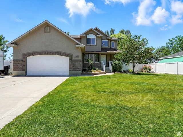 2591 Remuda Dr, Farr West, UT 84404 - view of front of home with stucco siding, an attached garage, and concrete driveway