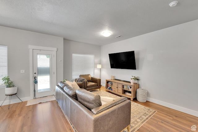 901 E 775 N, Layton, UT 84041 - living area featuring light wood-style flooring, baseboards, and a textured ceiling