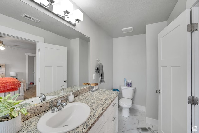 901 E 775 N, Layton, UT 84041 - bathroom with baseboards, vanity, marble look tiles, toilet, and a ceiling fan