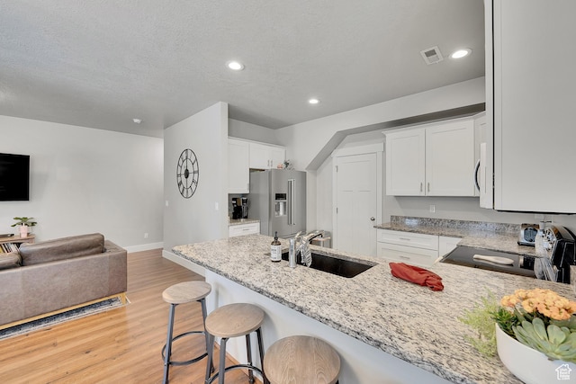 901 E 775 N, Layton, UT 84041 - kitchen with black electric range oven, a sink, high end refrigerator, light wood-style floors, and light stone counters