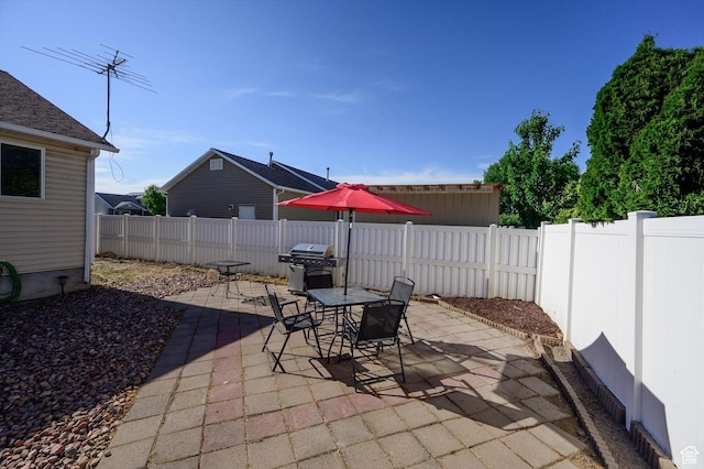 3139 S Timeron Dr, West Valley City, UT 84128 - fenced backyard with a patio, outdoor dining space, and a grill