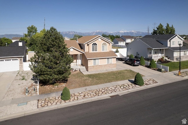 3139 S Timeron Dr, West Valley City, UT 84128 - traditional home with concrete driveway, a mountain view, a residential view, and stucco siding