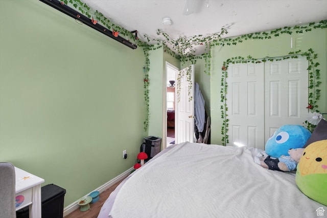 3139 S Timeron Dr, West Valley City, UT 84128 - bedroom featuring a closet, baseboards, and wood finished floors
