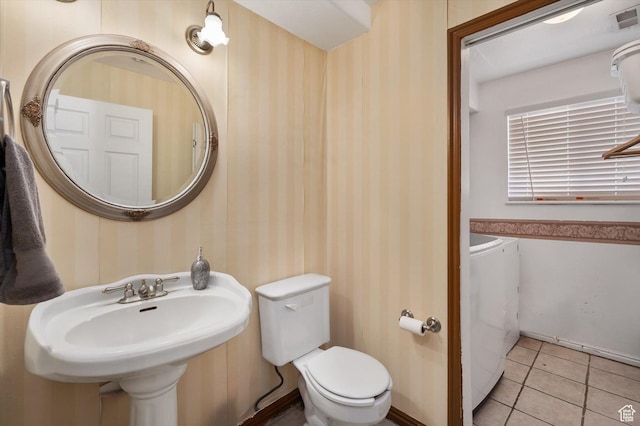 3139 S Timeron Dr, West Valley City, UT 84128 - bathroom with washer and clothes dryer, wallpapered walls, toilet, tile patterned floors, and a sink