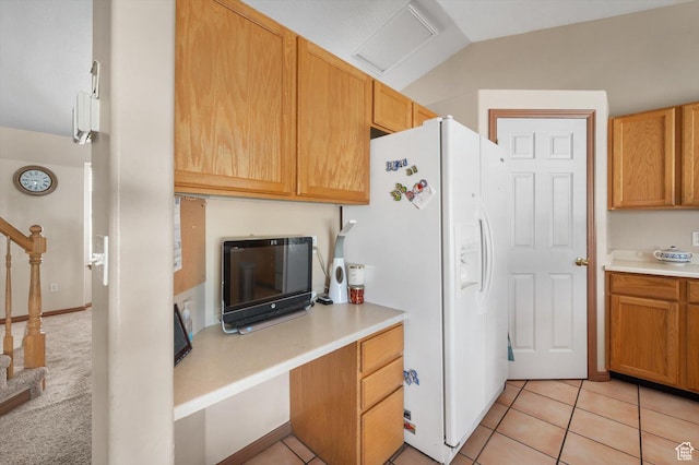 3139 S Timeron Dr, West Valley City, UT 84128 - kitchen with white refrigerator with ice dispenser, light countertops, vaulted ceiling, and light tile patterned flooring