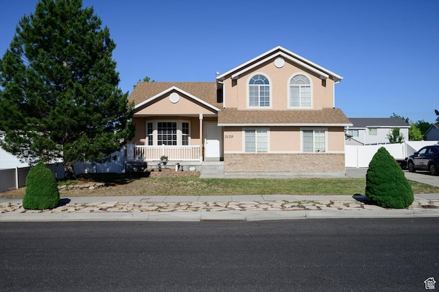 3139 S Timeron Dr, West Valley City, UT 84128 - view of front of home featuring a porch, stucco siding, and brick siding