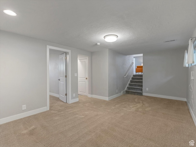 1555 E Fieldcrest Ln, Holladay, UT 84117 - finished below grade area with stairway, baseboards, light colored carpet, and a textured ceiling