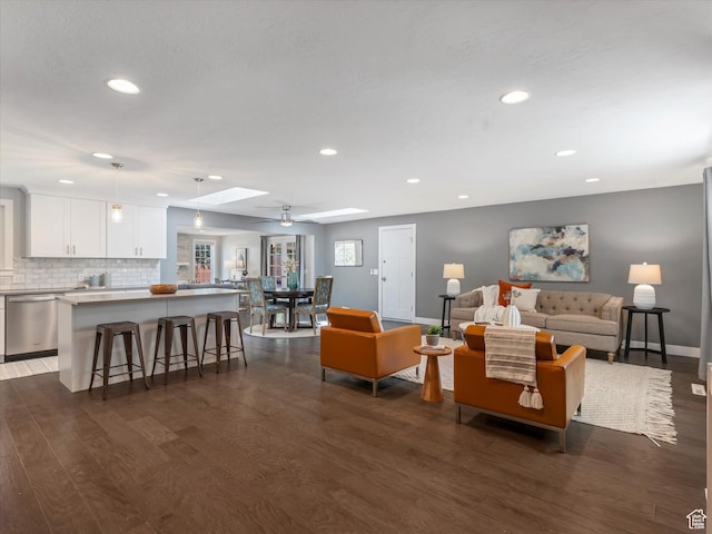 1555 E Fieldcrest Ln, Holladay, UT 84117 - living area with dark wood-style flooring, recessed lighting, a skylight, and baseboards