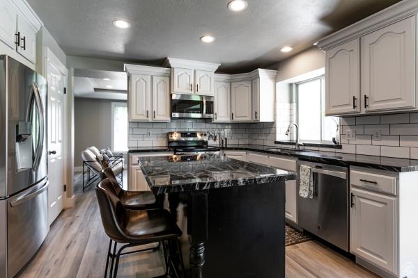 3007 W Sweet Clover Ln, South Jordan, UT 84095 - kitchen featuring appliances with stainless steel finishes, a sink, recessed lighting, healthy amount of natural light, and light wood-style flooring