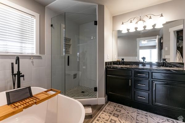 3007 W Sweet Clover Ln, South Jordan, UT 84095 - bathroom with a shower stall, a freestanding tub, double vanity, and wood finished floors