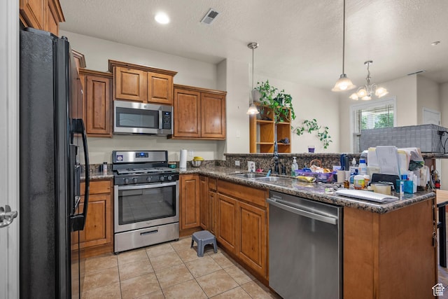 84 S 1630 W, Pleasant Grove, UT 84062 - kitchen with stainless steel appliances, brown cabinets, a peninsula, light tile patterned floors, and a chandelier