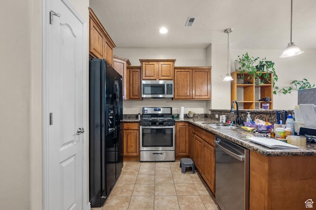84 S 1630 W, Pleasant Grove, UT 84062 - kitchen featuring appliances with stainless steel finishes, a sink, brown cabinetry, hanging light fixtures, and a peninsula